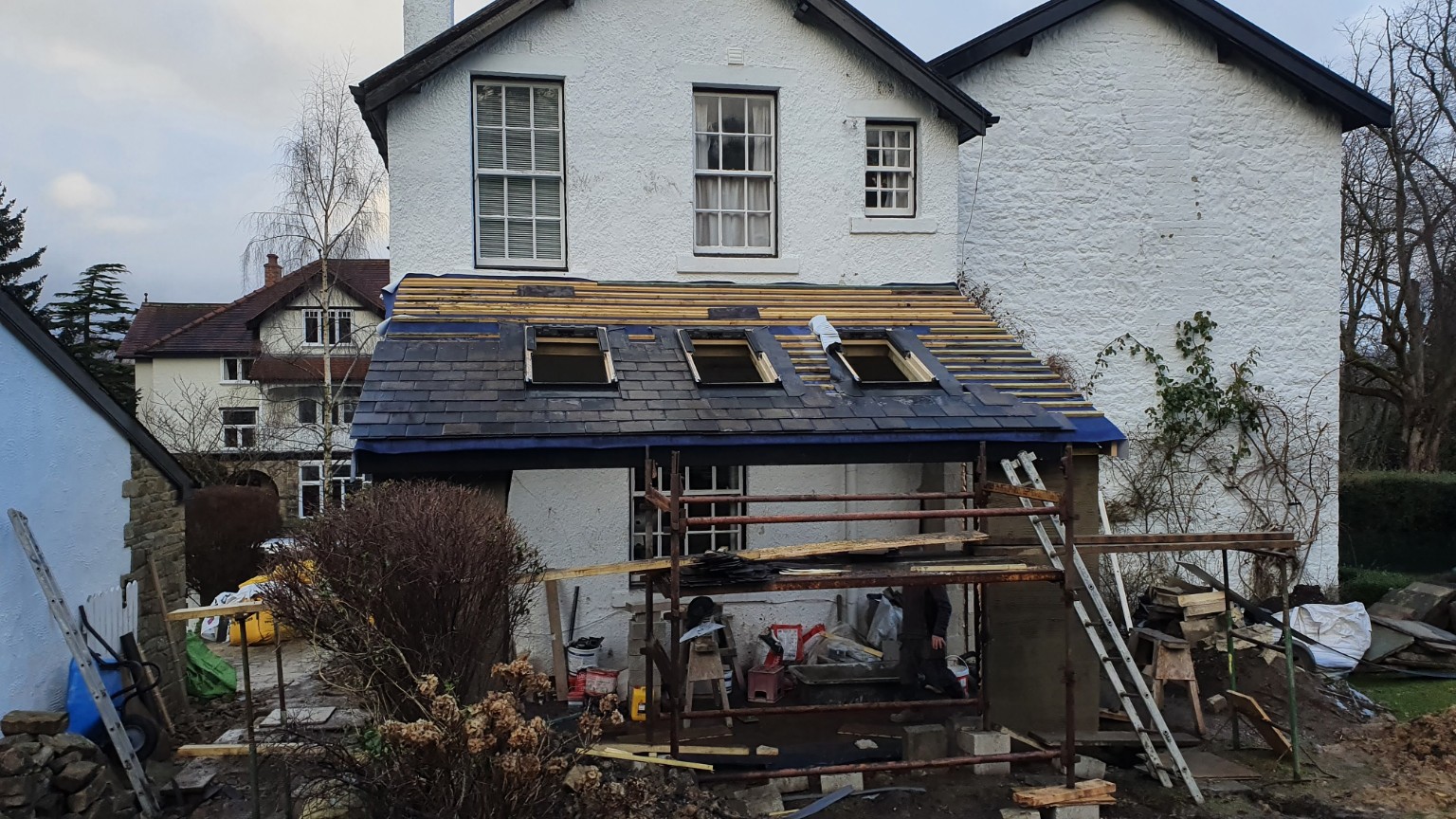 Slate roof and three rooflights being installed